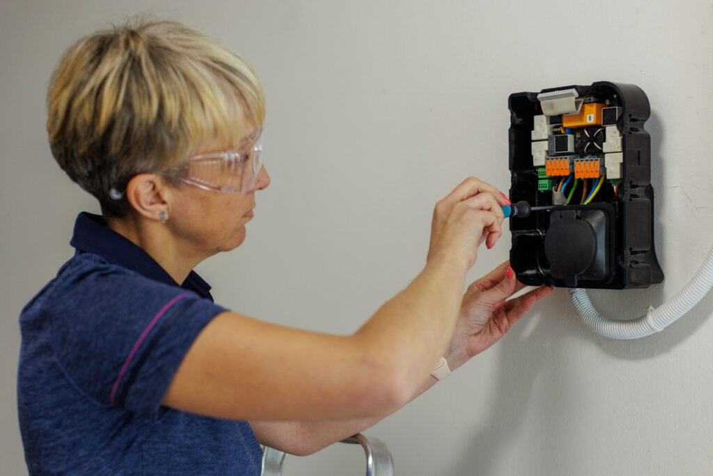 Certified Female Electrician Installing Home EV Charger